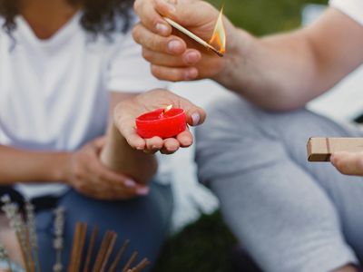 Close up of a candle and incense in a room