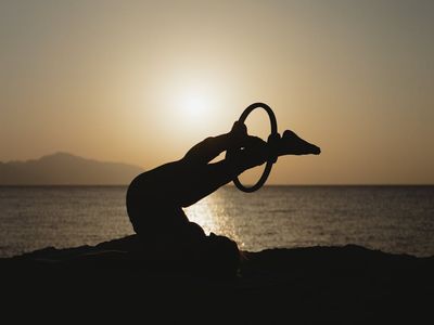 Silhouette of a person doing a morning stretch