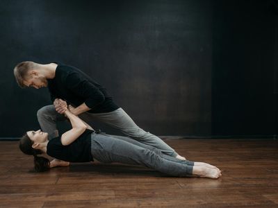 Woman practicing a balance pose in a dark hall